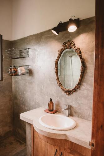 a bathroom with a sink and a mirror on the wall at El Rincón - Casa de campo in Carmelo