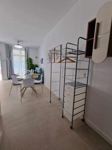 a room with a bunk bed and a dining room at Urban suite 1 in Málaga