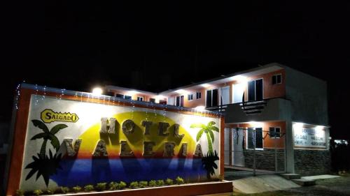 a building with a mural on the side of it at night at Hotel Valeria in Tecolutla