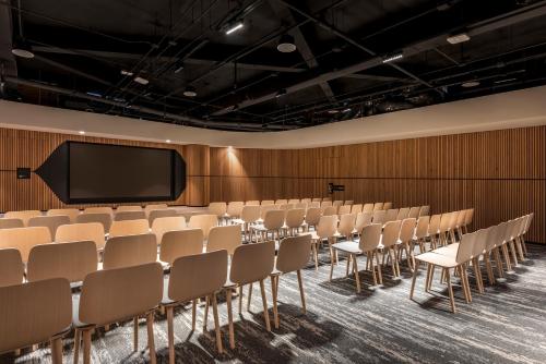an empty lecture hall with chairs and a screen at Andaz Condesa Mexico City, By Hyatt in Mexico City