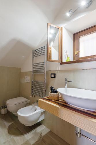 a bathroom with a sink and a toilet at Il Tramonto Holidays in Trevi