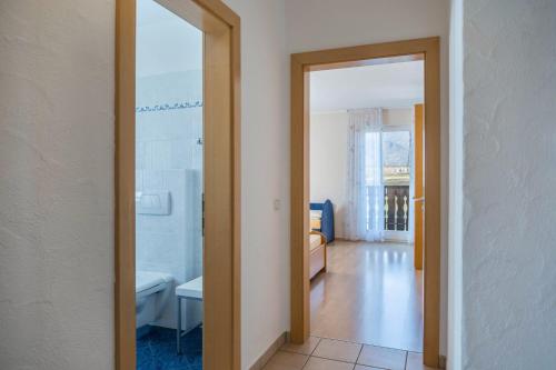 a hallway with a door open to a living room at Valtlhof - Apt 2 in Cornaiano