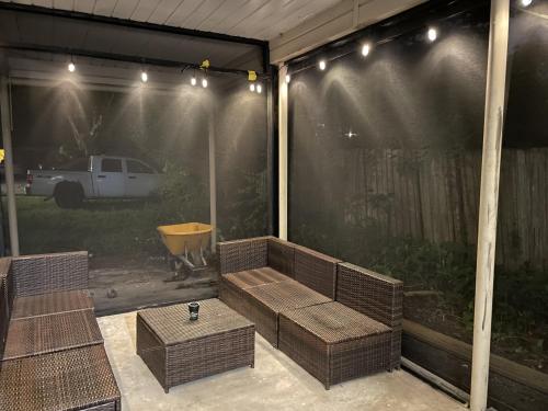 a screened in porch with a bench and a table at Terrace Guest House in Tampa