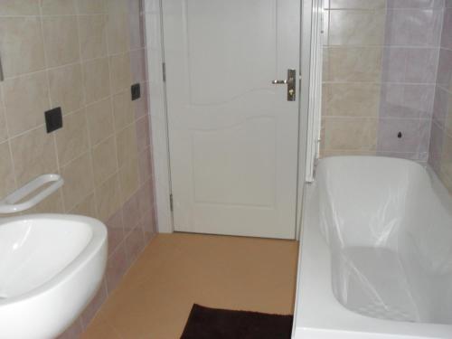 a bathroom with a tub and a toilet and a sink at Residence Le Groane in Garbagnate Milanese