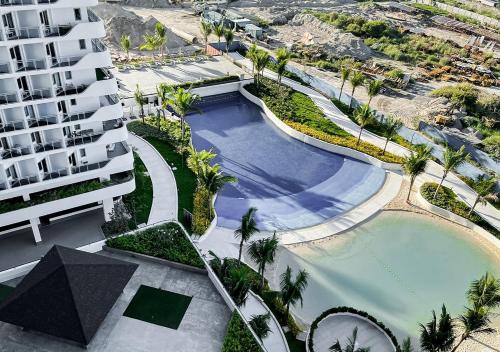 an overhead view of a swimming pool next to a building at Largest 2-Bed Studio in Azure North, Pampanga in San Fernando