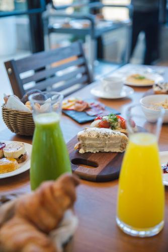 a wooden table with food and drinks on it at Exclusive Gramado Hotel & Spa by Gramado Parks in Gramado