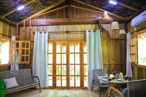 a living room with a table and a window at POUSADA BAWARY in São Gabriel da Cachoeira