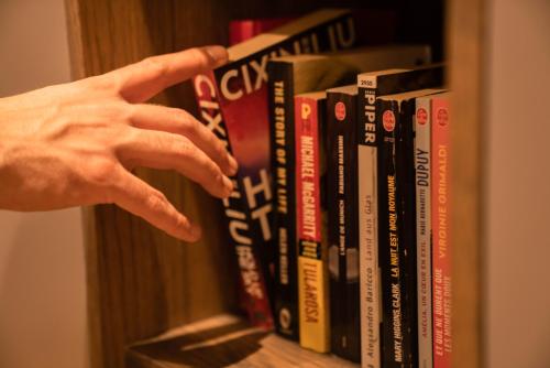 a hand is reaching for a shelf of books at Slavija Culture Heritage Hotel in Split