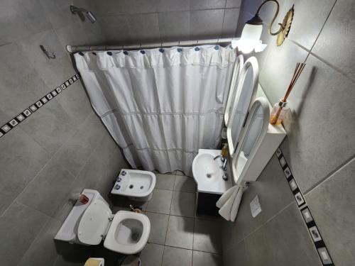 a small bathroom with two toilets and a sink at Casa Barrio Cooperativo Villa Maria in San Juan