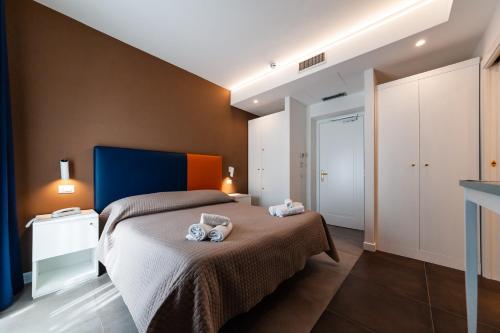 a bedroom with a bed with two towels on it at Loriana Park Hotel Sul Lago in Bolsena