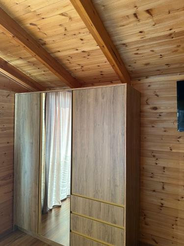 a room with a wooden wall with a window at Kingfish restaurant & boutique hotel in Patog