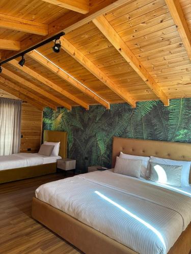 a bedroom with a large bed in a room at Kingfish restaurant & boutique hotel in Patog