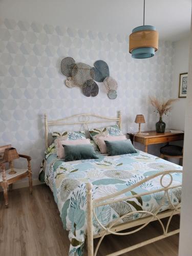 um quarto com uma cama com almofadas em chambre d'hôte chez Mimidid em Le Landreau