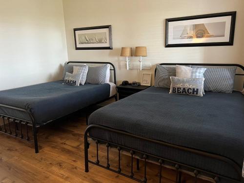 two beds in a hotel room with at Inn at Camachee Harbor View Suite 27 in Saint Augustine