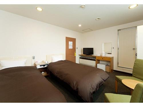 a hotel room with two beds and a desk and a television at Hotel Marui - Vacation STAY 14597v in Shibata