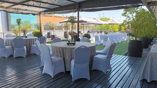 a set up for a wedding with white tables and chairs at Hotel Casino Talca in Talca