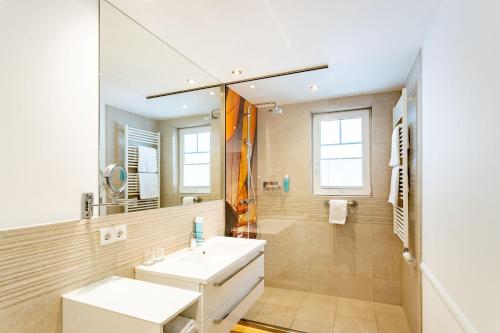 a bathroom with a sink and a mirror at Victoria Suites in Bad Saarow