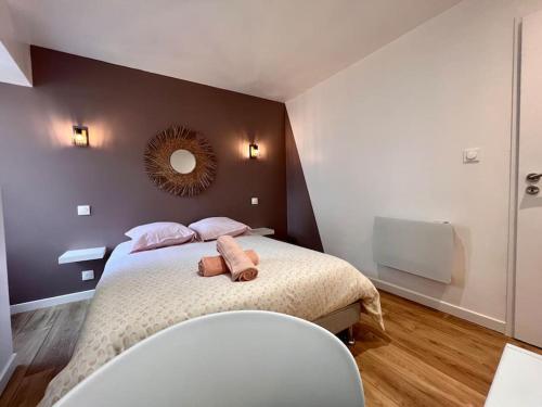 a bedroom with a bed with a mirror on the wall at LA PALMERAIE -wifi fibre- centre ville -PROPERTY RENTAL NM in Fontenay-le-Comte