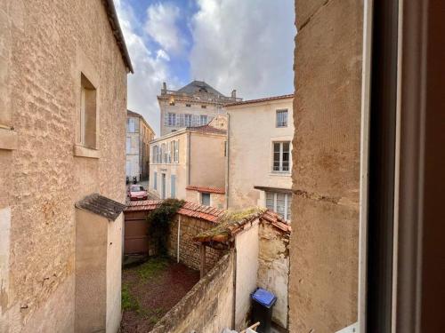 a view from a window of an alley with buildings at LA PALMERAIE -wifi fibre- centre ville -PROPERTY RENTAL NM in Fontenay-le-Comte