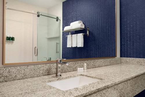 a bathroom with a sink and a mirror at Fairfield Inn by Marriott Visalia Sequoia in Visalia