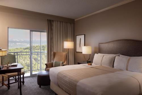 a hotel room with a bed and a large window at La Cantera Resort & Spa in San Antonio