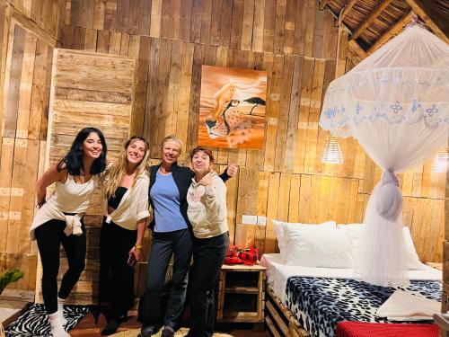 a group of people standing in a room with a bed at Serengeti Villa in Arusha