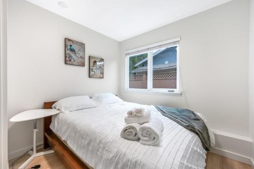 a bedroom with a bed with towels on it at Luxury Delta 2BD Suit on ground floor in Delta