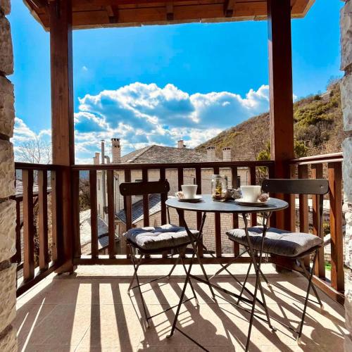 a patio with a table and chairs on a deck at Giagia Evgenia in Vitsa