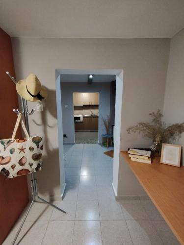 a hallway with a table and a chair in a room at Lofos house in Karavadhos