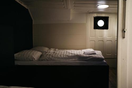 a bed in a room with a light on the door at Botel Maastricht in Maastricht
