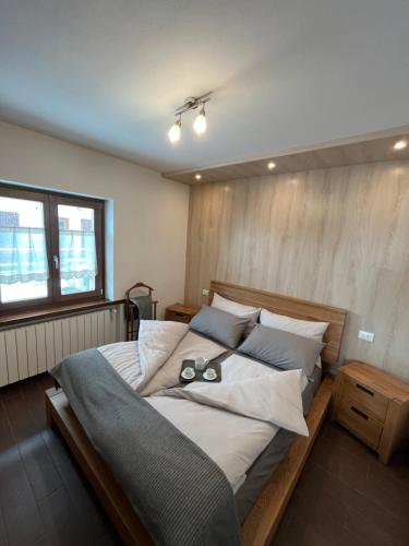 a bedroom with a large bed with two glasses on it at Baita PierGi in Livigno