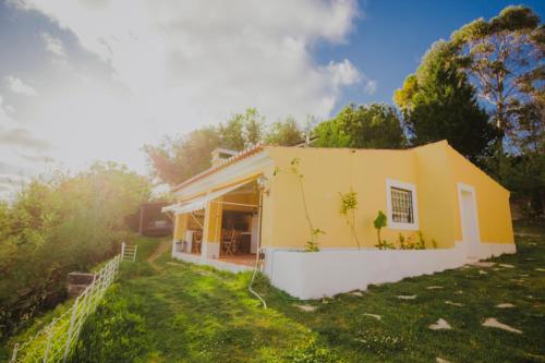 a small yellow house in a yard at 2Bedroom house with Swimming Pool and View in Moçarria