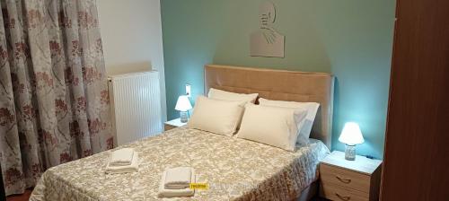 a bedroom with a bed with two phones on it at Mountainside in Vounoplagiá