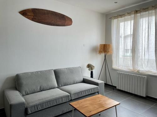 un salon avec un canapé et une table dans l'établissement Gîte Shaka, à Gravelines