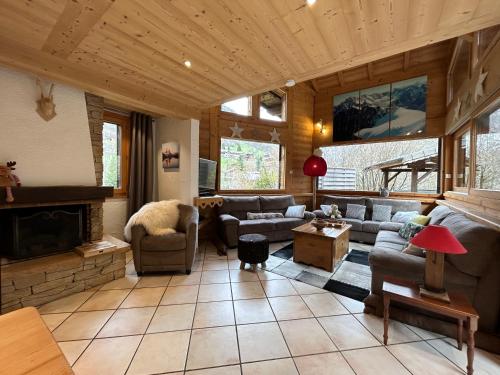 a living room with a couch and a fireplace at Chalet Adonis - Montriond, Morzine, Avoriaz in Montriond