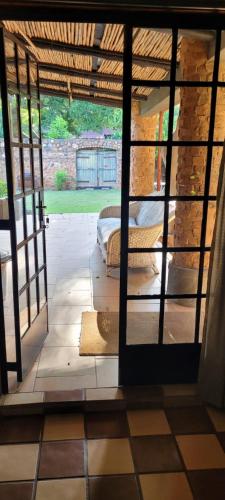 a view of a room with a bed through a window at Mill Lane Farmhouse in Hartbeespoort