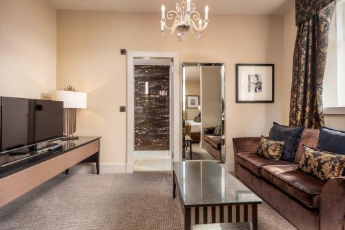 a living room with a couch and a tv at The Kylestrome in Ayr