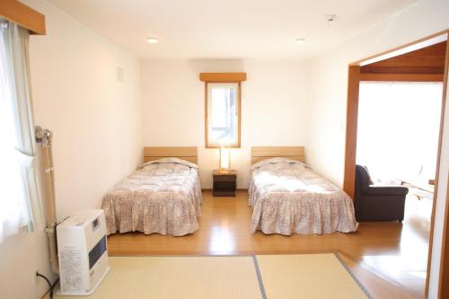 a room with two beds and a television in it at Esashi-gun - Cottage - Vacation STAY 38350v in Pinneshiri