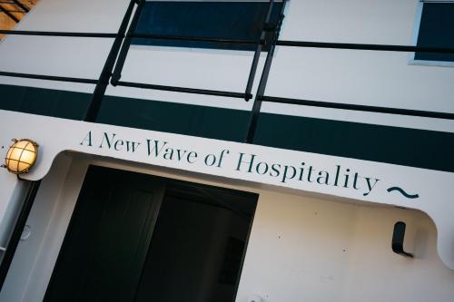 a new wave of hospitality sign on a building at Botel Maastricht in Maastricht