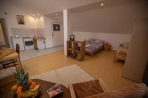 a living room with a kitchen and a living room with a table at Apartmani Lazić in Ribarska Banja