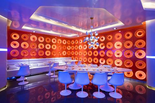 a dining room with a long table and blue chairs at Nickelodeon Hotels & Resorts Punta Cana - Gourmet All Inclusive by Karisma in Punta Cana