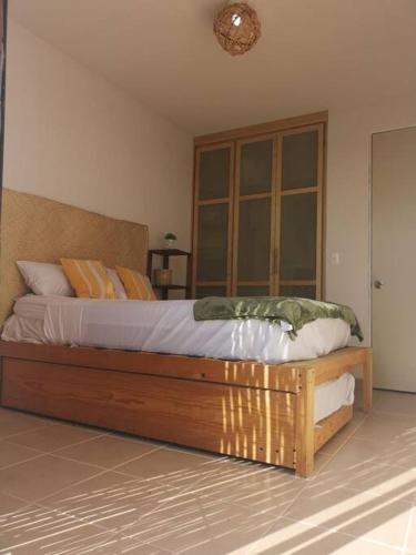 a bedroom with a large wooden bed in a room at Dafi´s House (Exclusivo con jardín) in Ayala