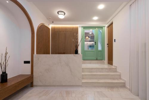 a hallway with stairs and a green door at Sartori Concept Hotel in Heraklio Town