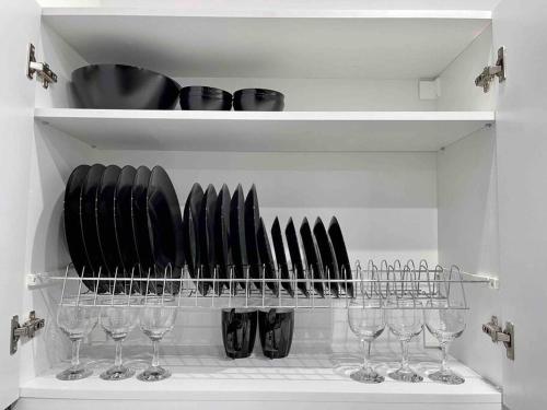 a shelf with a bunch of knives and wine glasses at ATH Luxury Central apartment in Athens