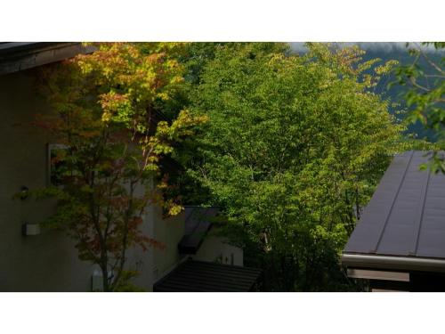 a view of two trees in front of a building at Innterhill Tsubasa Yufuin - Vacation STAY 94225v in Yufuin