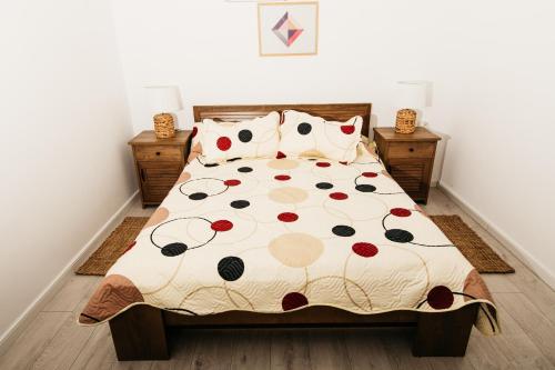 a bedroom with a bed with a comforter and pillows at EVRA APARTMENTS in Recaş