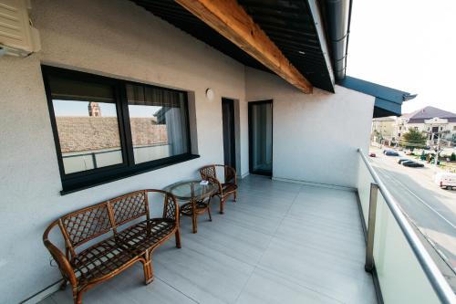 a balcony with two chairs and a table at EVRA APARTMENTS in Recaş