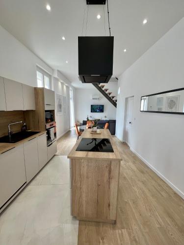 - une cuisine avec un îlot au milieu d'une pièce dans l'établissement Appartement spacieux & lumineux, à Lieuran-lès-Béziers