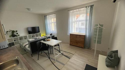 a bedroom with a bed and a table and a desk at Fara N°71 APART 1 in Libice nad Cidlinou