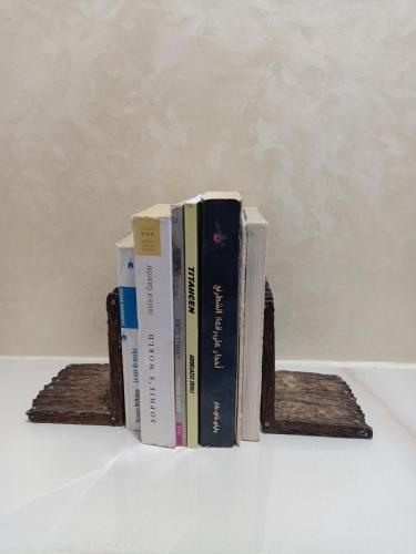 a stack of books sitting on wooden shelves at Harmony in Azrou